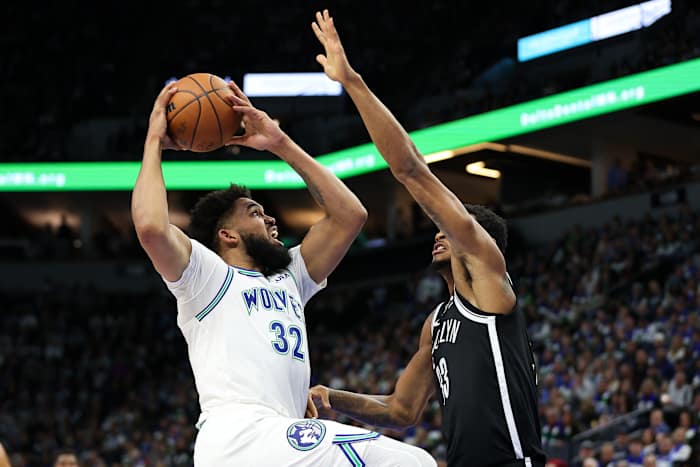 Minnesota Timberwolves center Karl-Anthony Towns (32) shoots as Brooklyn Nets center Nic Claxton (33) defends during the first half at Target Center in Minneapolis on Feb. 24, 2024.